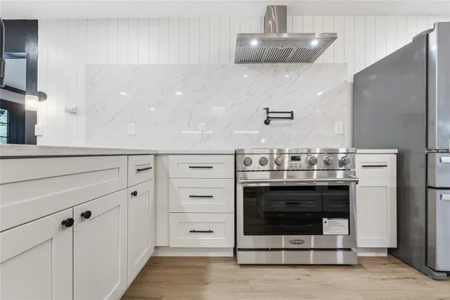 a bathroom with a sink a glass door shower and a mirror