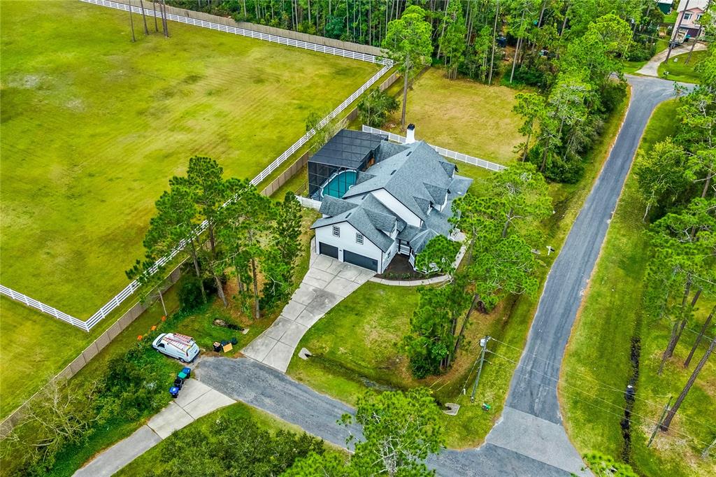 14728 Henson Road Orlando, FL 32832 - Photo 3 of 70 an aerial view of a house with swimming pool and garden