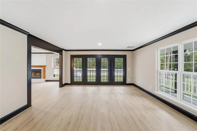 a spacious bedroom with a bed and a large window