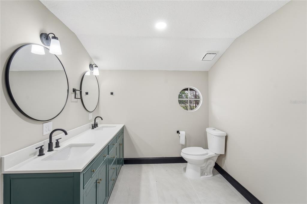 14728 Henson Road Orlando, FL 32832 - Photo 61 of 70 a bathroom with a toilet sink and mirror