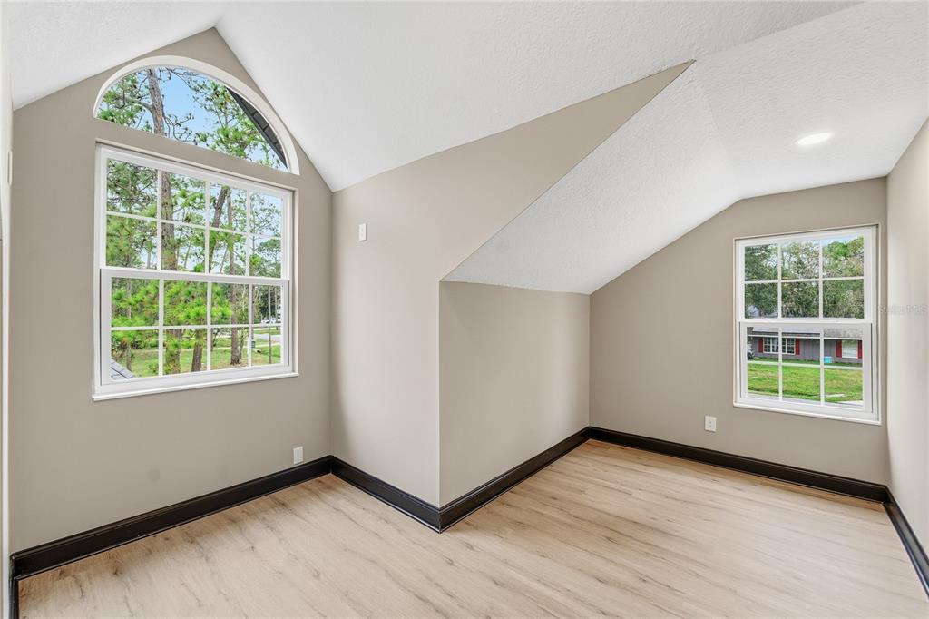 14728 Henson Road Orlando, FL 32832 - Photo 62 of 70 an empty room with wooden floor and windows