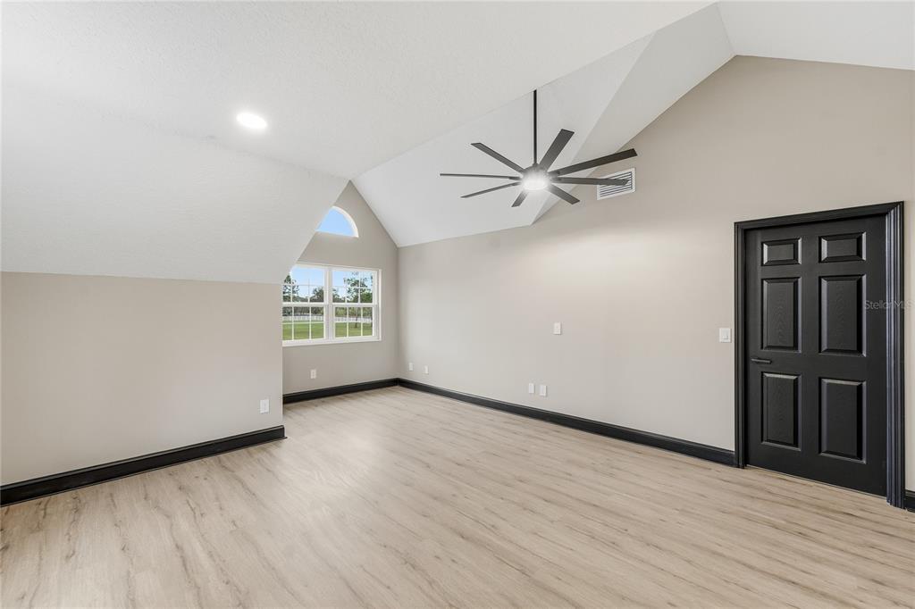 14728 Henson Road Orlando, FL 32832 - Photo 65 of 70 an empty room with wooden floor closet and windows