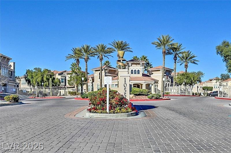 10550 West Alexander Road, Unit 2148 Las Vegas, NV 89129 - Photo 7 of 41 A grand gated entrance welcomes residents to this community with lush landscaping and mature palm trees.