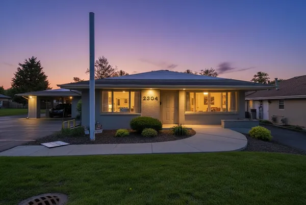 a view of a house with a backyard