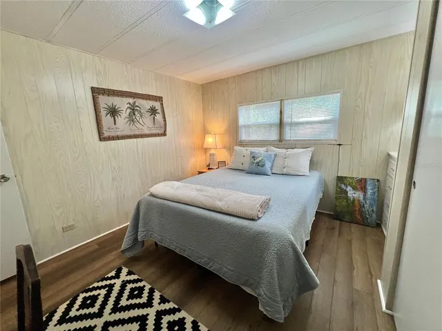 a view of a house with backyard and trees