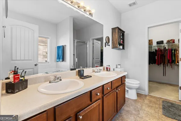 a bathroom with a sink double vanity and a toilet