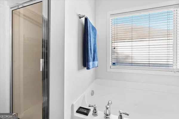 a bathroom with a bathtub and a window