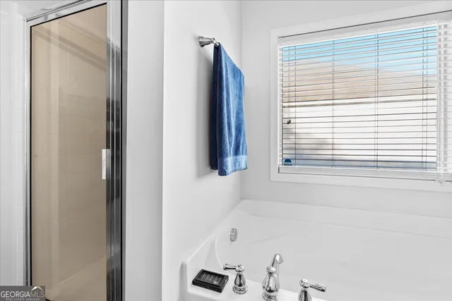 a bathroom with a bathtub and a window