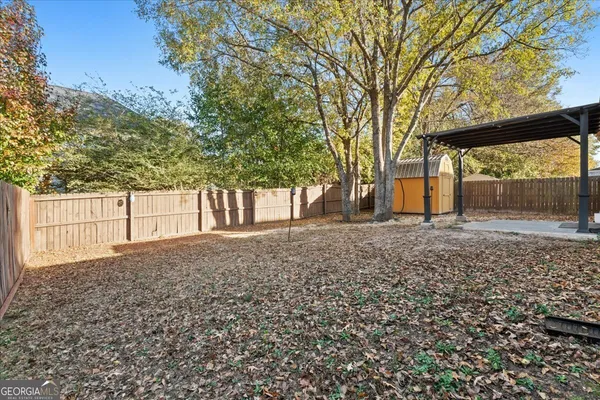 a view of a backyard with large trees