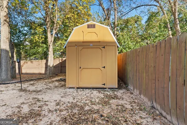 a view of a wooden door in front of a house