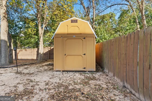 a view of a wooden door in front of a house