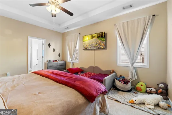 a bedroom with a bed and a chandelier