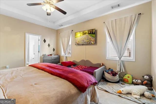 a bedroom with a bed and a chandelier