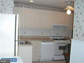 320 Lippincott Avenue Riverside, NJ 08075 - Photo 8 of 12 a kitchen with granite countertop white cabinets and white appliances