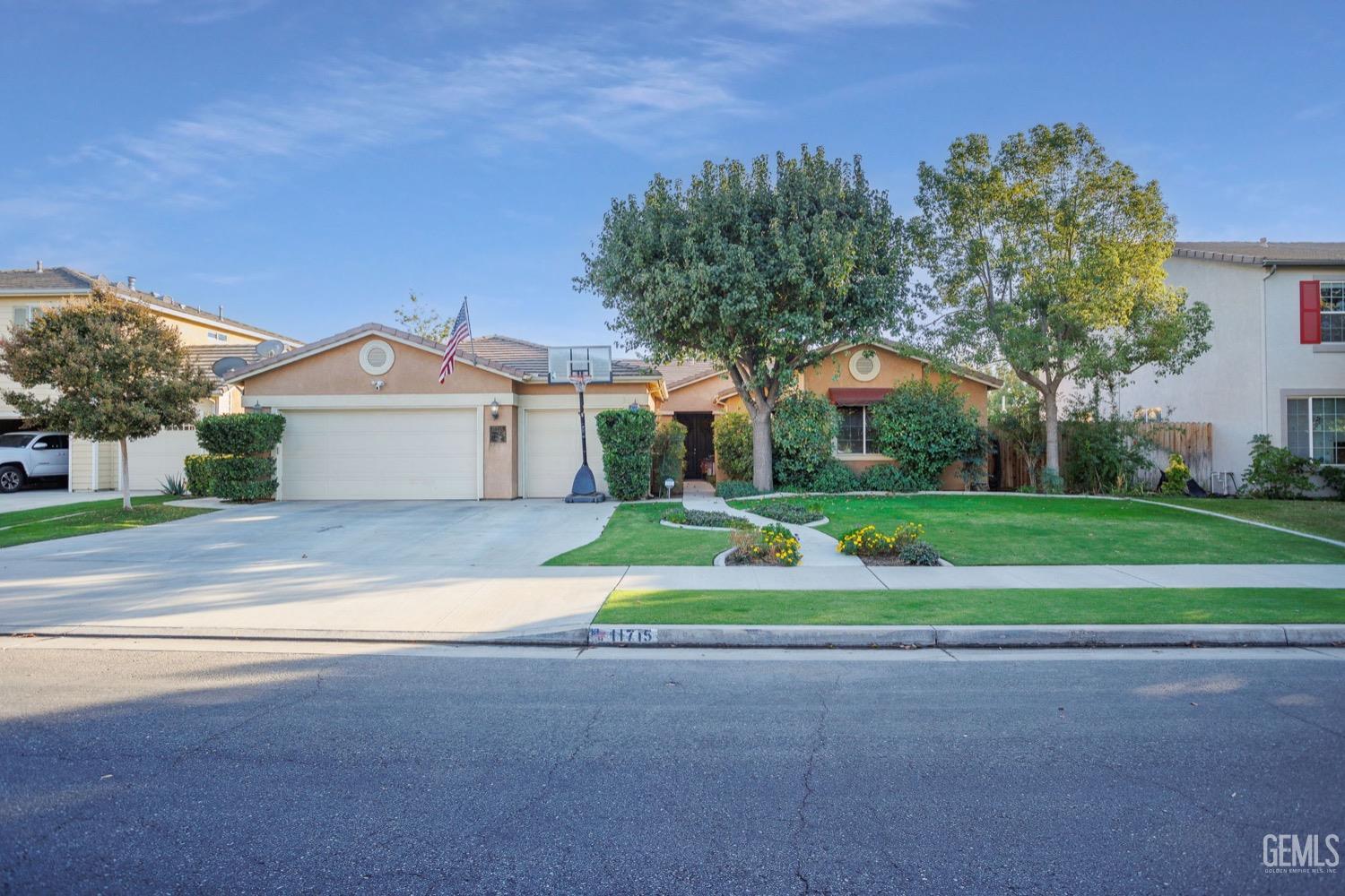 Undisclosed Address Bakersfield, CA 93312 - Photo 1 of 45 a front view of house with yard and green space