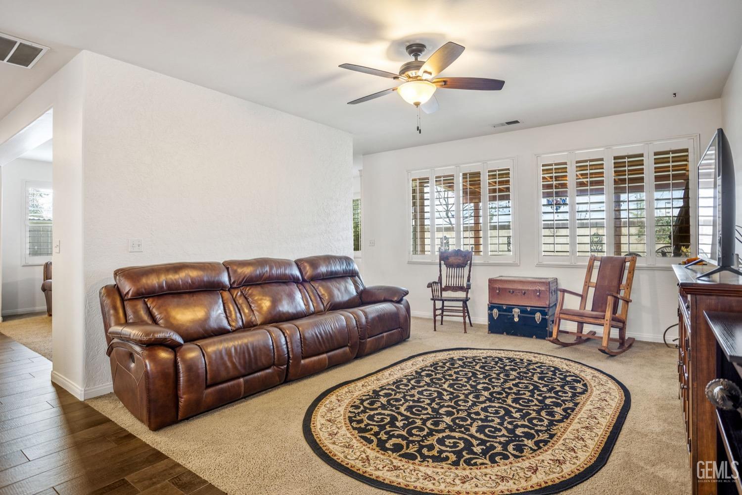 Undisclosed Address Bakersfield, CA 93312 - Photo 11 of 45 a living room with furniture a fireplace and a table