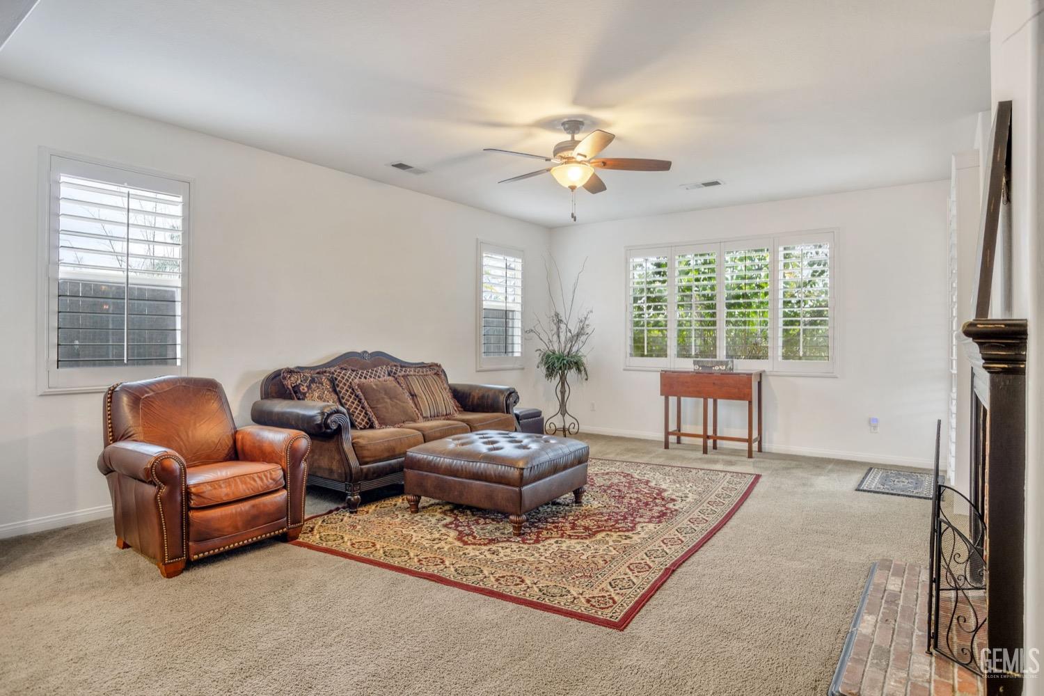 Undisclosed Address Bakersfield, CA 93312 - Photo 14 of 45 a living room with furniture a fireplace and a table