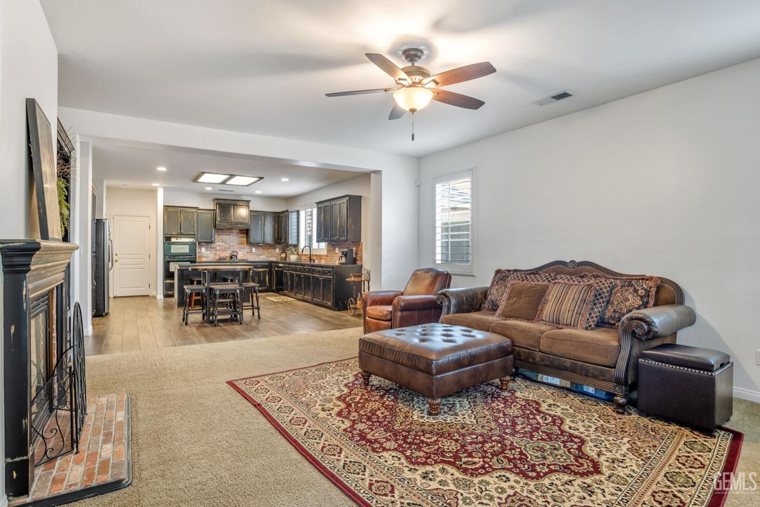 Undisclosed Address Bakersfield, CA 93312 - Photo 17 of 45 a living room with furniture kitchen view and a chandelier