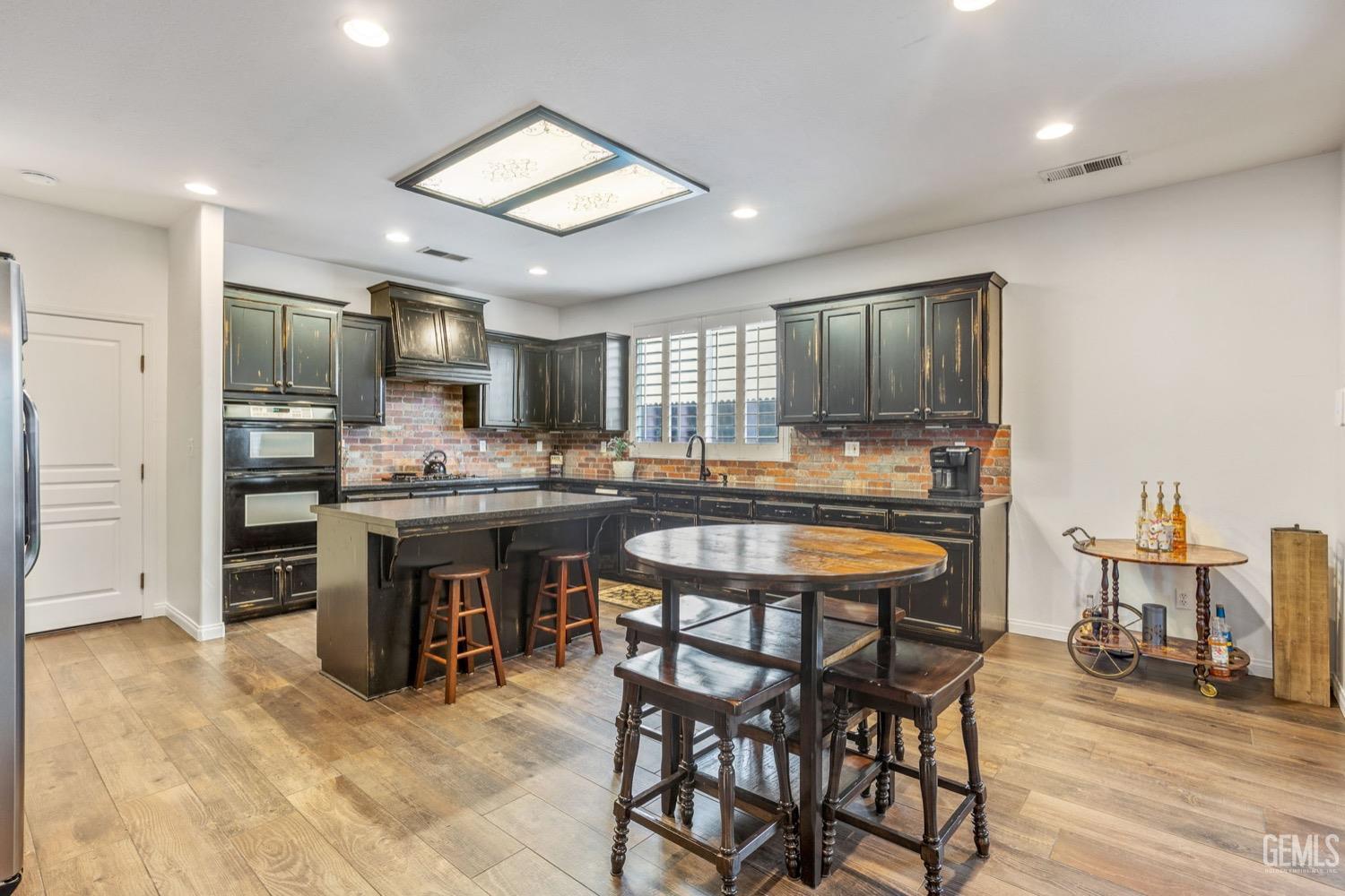 Undisclosed Address Bakersfield, CA 93312 - Photo 18 of 45 a kitchen with a table and chairs in it
