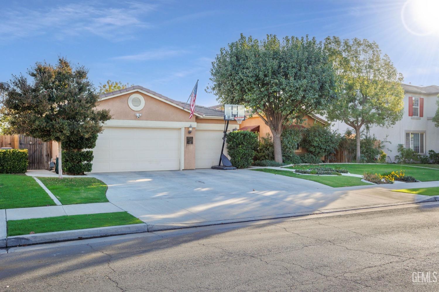 Undisclosed Address Bakersfield, CA 93312 - Photo 2 of 45 a front view of a house with a yard and garage