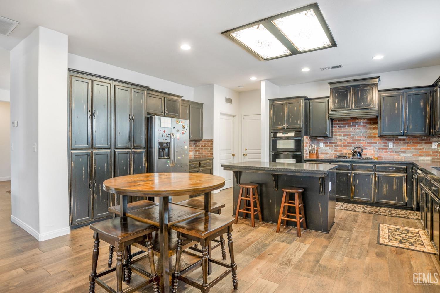 Undisclosed Address Bakersfield, CA 93312 - Photo 25 of 45 a kitchen with a table and chairs in it