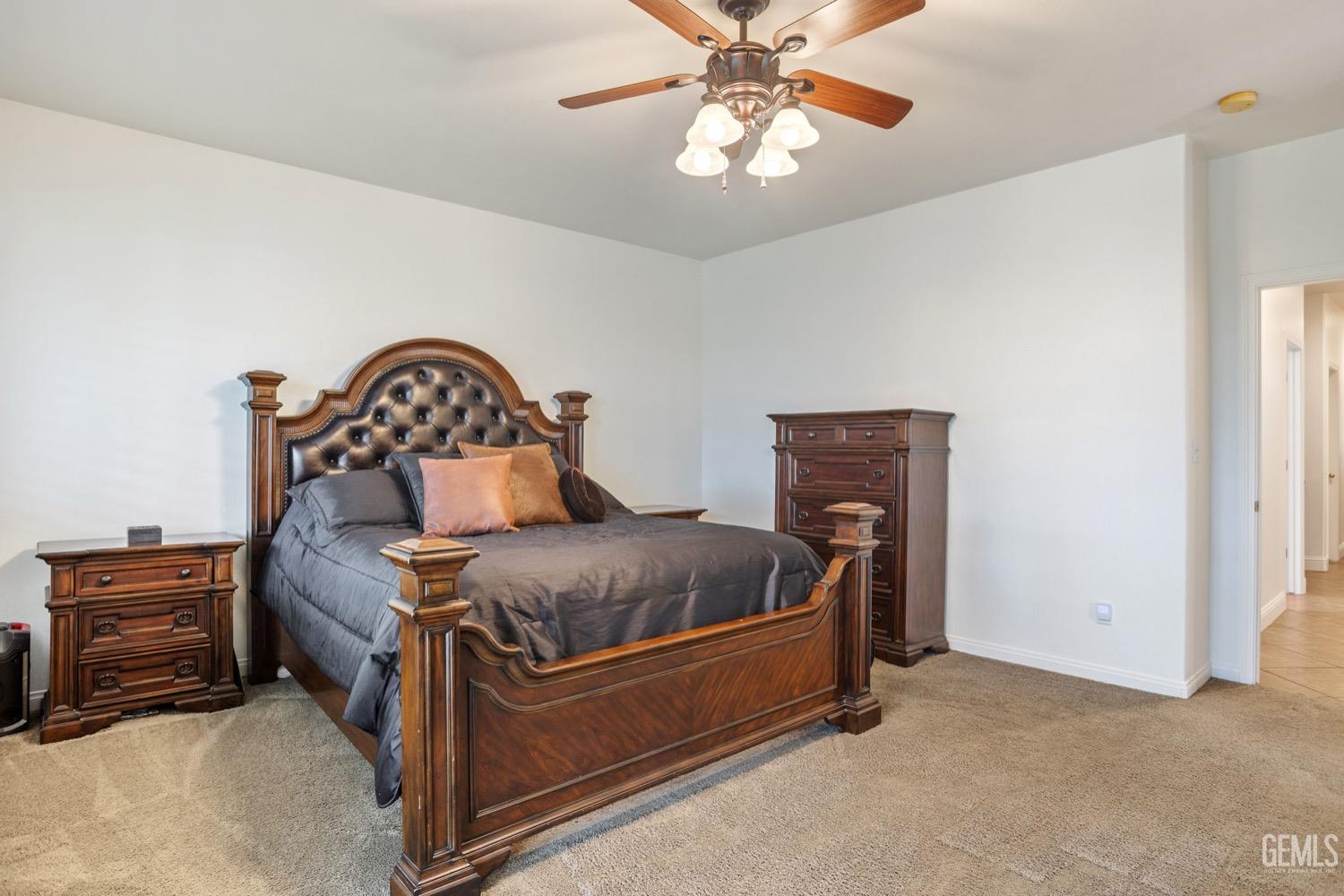 Undisclosed Address Bakersfield, CA 93312 - Photo 30 of 45 a bedroom with a bed and a chandelier