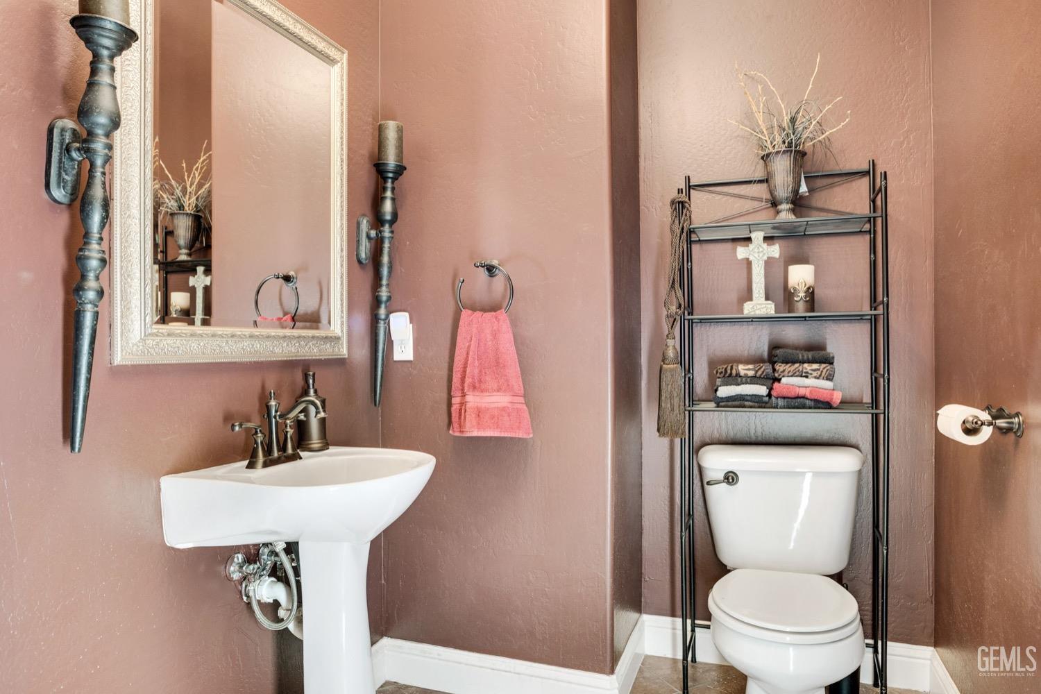 Undisclosed Address Bakersfield, CA 93312 - Photo 33 of 45 a bathroom with a toilet sink and mirror