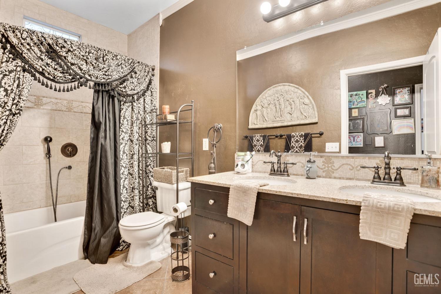 Undisclosed Address Bakersfield, CA 93312 - Photo 37 of 45 a bathroom with a granite countertop sink mirror vanity and toilet