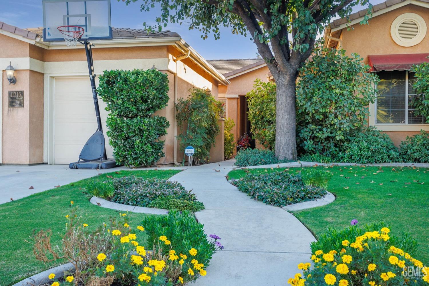 Undisclosed Address Bakersfield, CA 93312 - Photo 4 of 45 a front view of a house with a yard