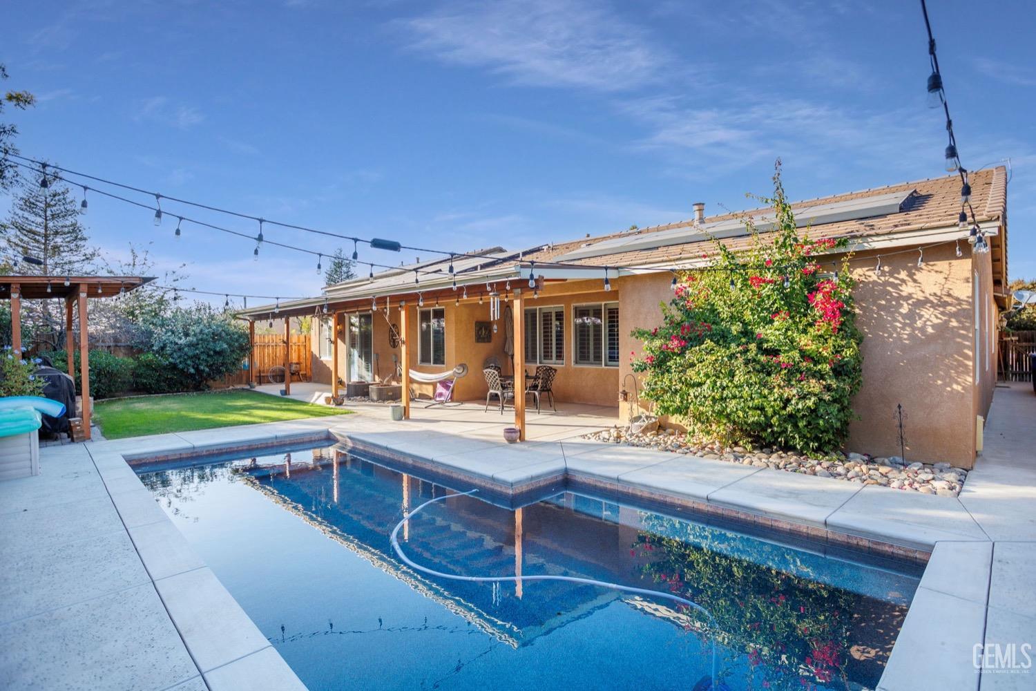 Undisclosed Address Bakersfield, CA 93312 - Photo 45 of 45 a patio with table and chairs and potted plants