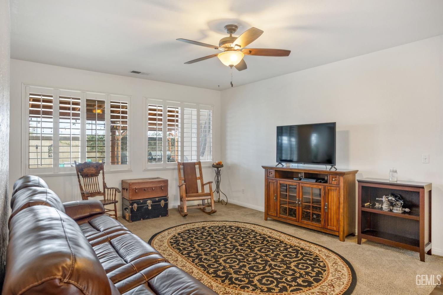 Undisclosed Address Bakersfield, CA 93312 - Photo 10 of 45 a living room with furniture and a flat screen tv