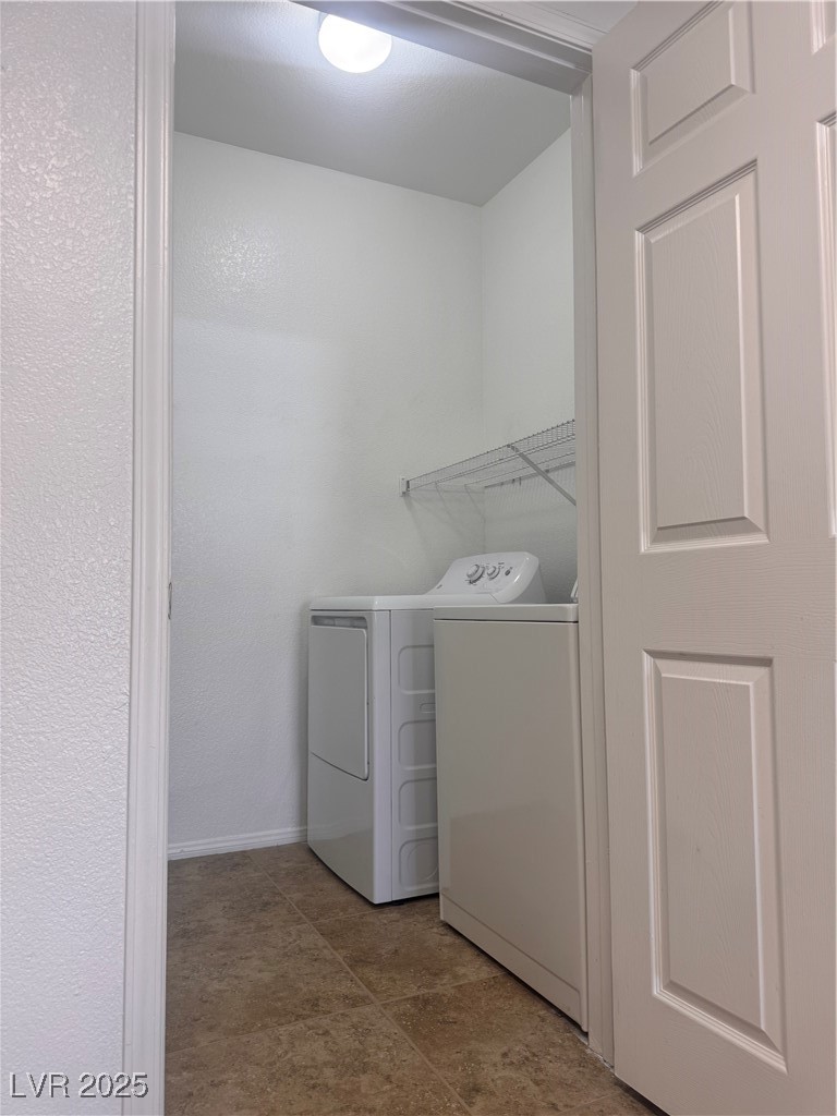 9975 Peace Way, Unit 1140 Las Vegas, NV 89147 - Photo 14 of 23 Laundry room with washing machine and clothes dryer, laundry area, and baseboards