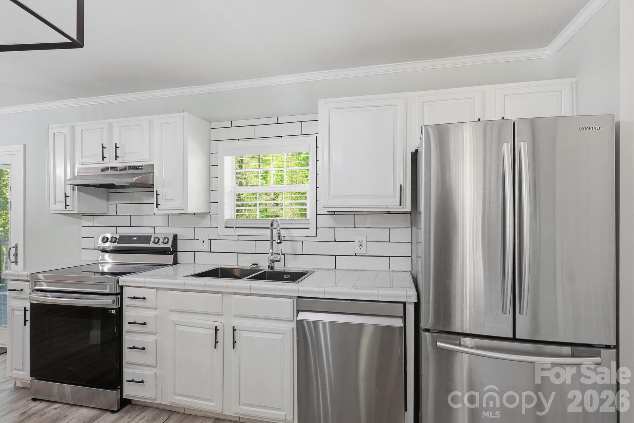 116 Springdale Drive York, SC 29745 - Photo 7 of 32 a kitchen with stainless steel appliances a refrigerator sink and cabinets