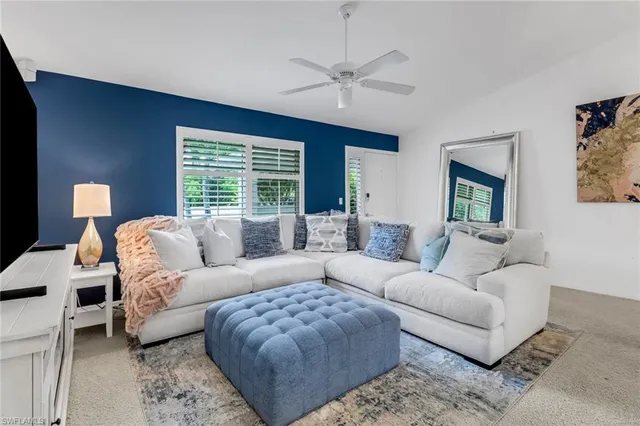 a living room with furniture ceiling window and a fireplace