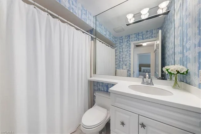 a bedroom with two beds and a chandelier