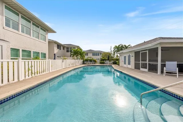 a view of a swimming pool with a table and chairs