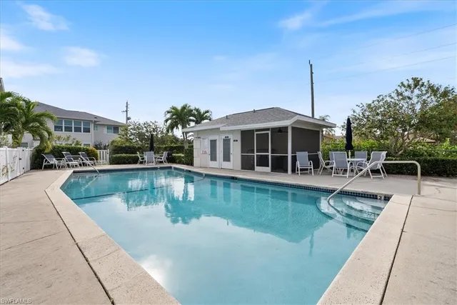 a view of swimming pool with outdoor seating