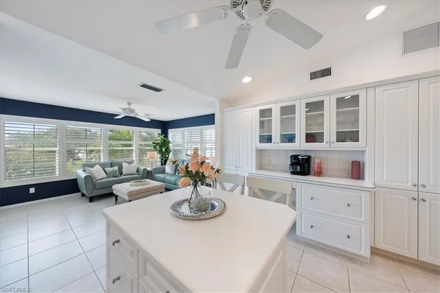 a living room with furniture large window and wooden floor