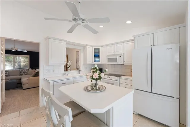 a kitchen with stainless steel appliances a sink and a refrigerator