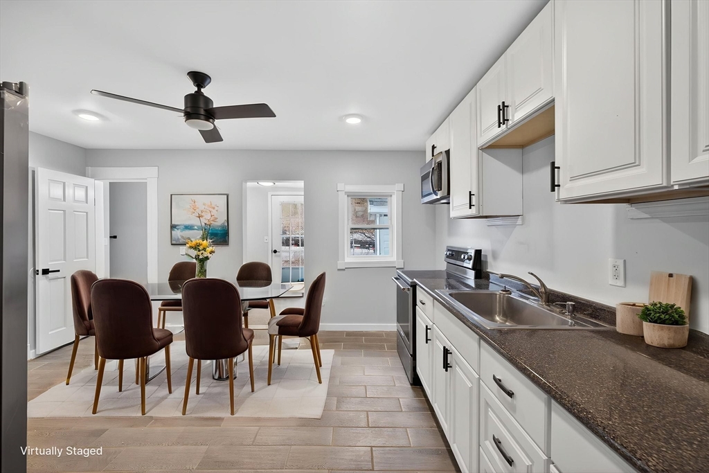 77 Off Hamilton Street Southbridge, MA 01550 - Photo 16 of 42 a large kitchen with stainless steel appliances granite countertop a sink a stove and a refrigerator