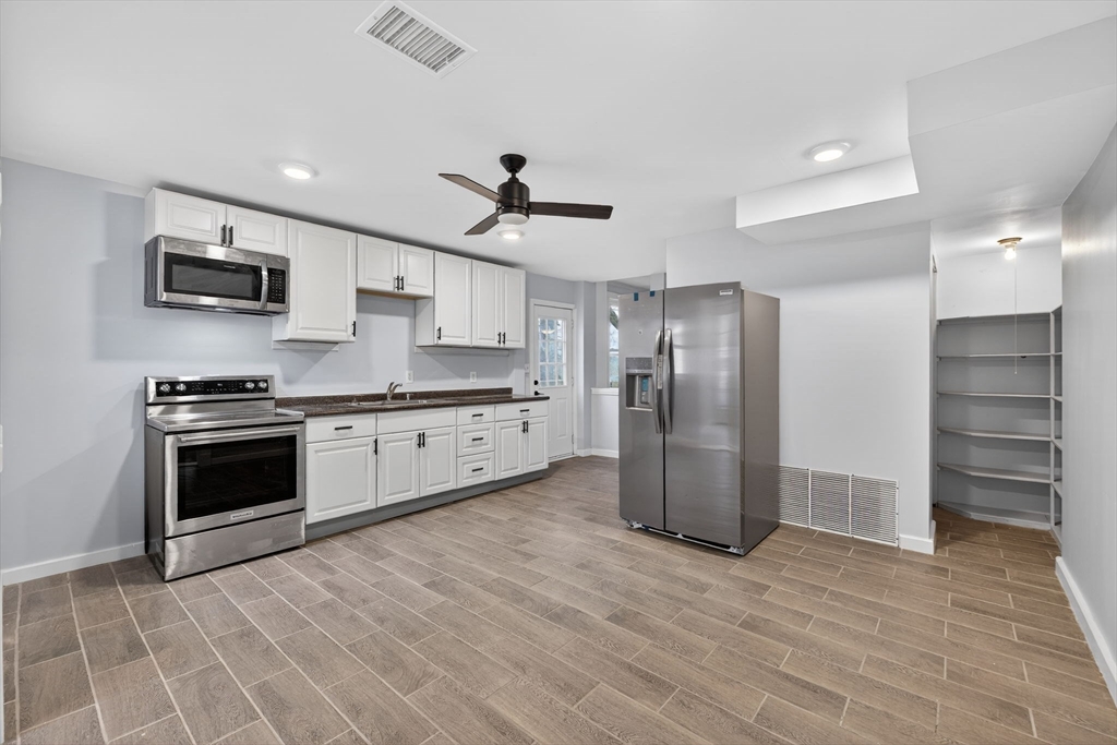 77 Off Hamilton Street Southbridge, MA 01550 - Photo 17 of 42 a kitchen with stainless steel appliances a refrigerator sink and stove