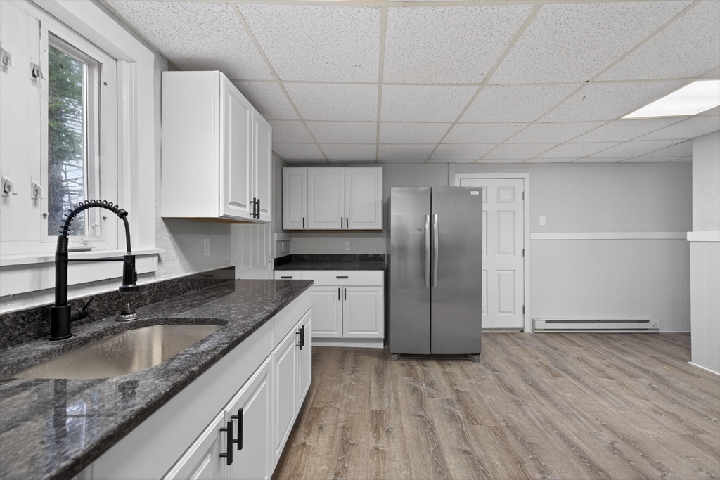 77 Off Hamilton Street Southbridge, MA 01550 - Photo 20 of 42 a kitchen with granite countertop stainless steel appliances a sink window and cabinets
