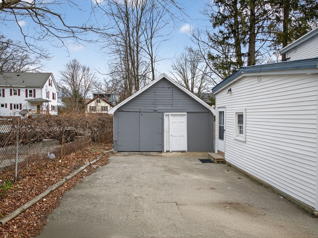 77 Off Hamilton Street Southbridge, MA 01550 - Photo 3 of 42 a view of a house with a yard and garage