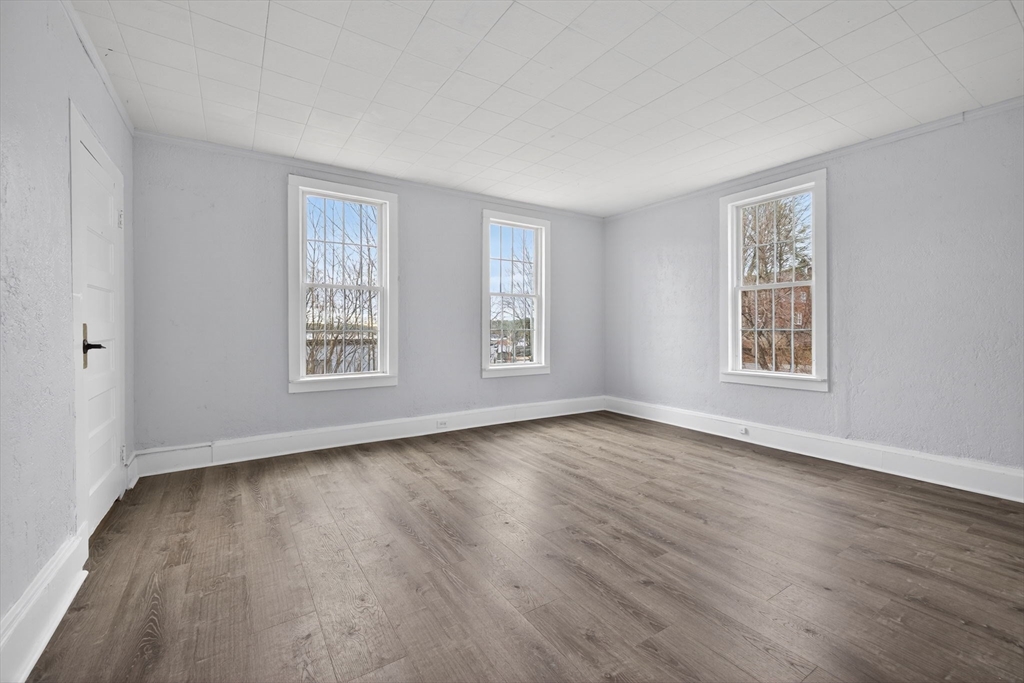 77 Off Hamilton Street Southbridge, MA 01550 - Photo 7 of 42 a view of an empty room with wooden floor and a window