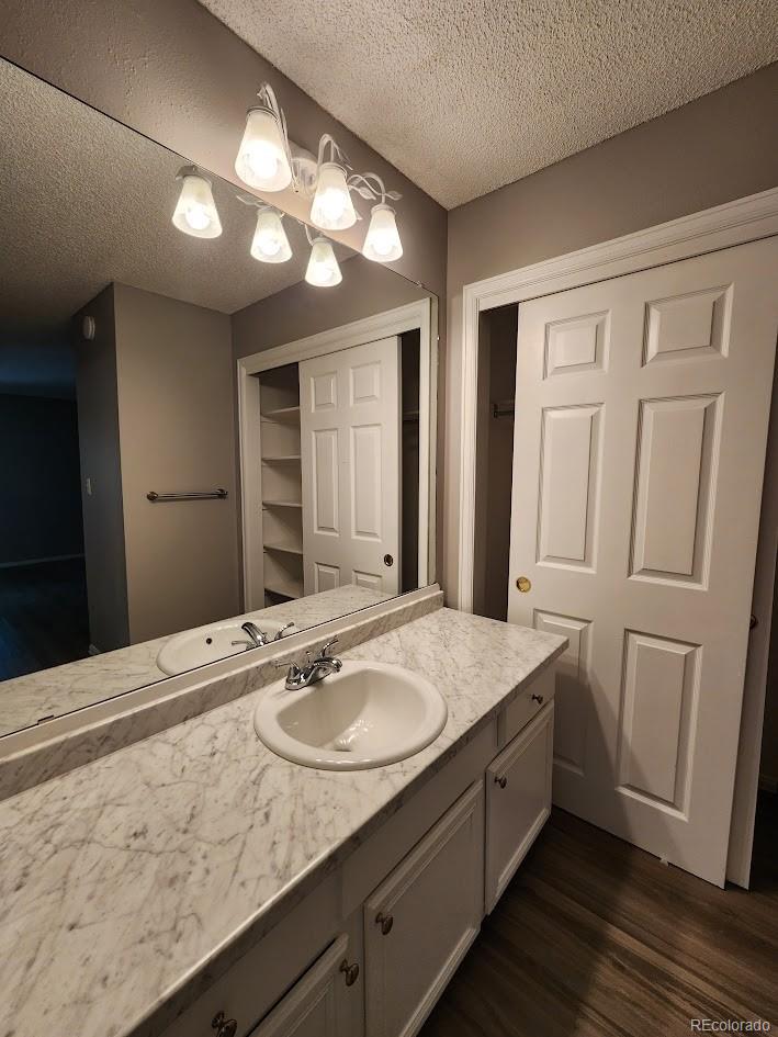 2685 South Dayton Way, Unit 365 Denver, CO 80231 - Photo 12 of 24 a bathroom with a granite countertop sink and a mirror