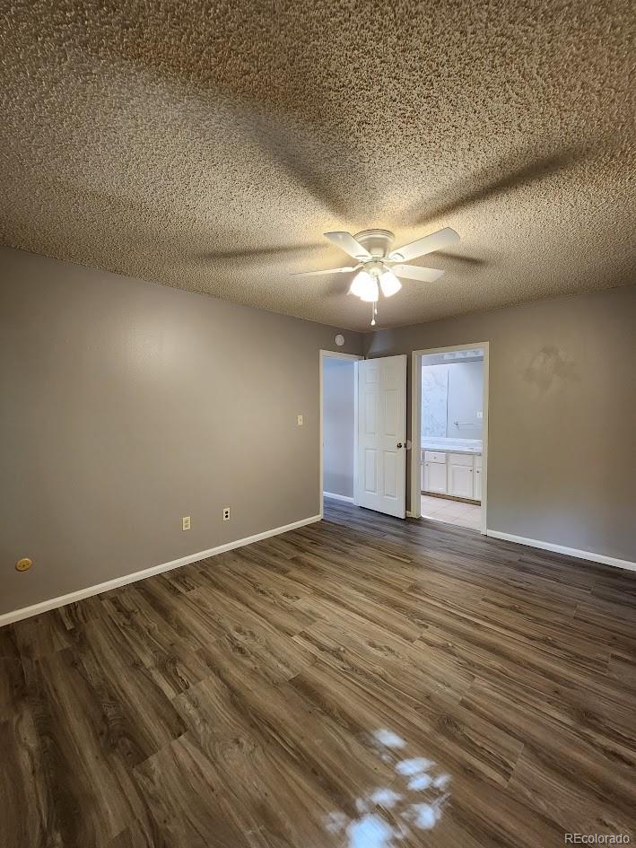 2685 South Dayton Way, Unit 365 Denver, CO 80231 - Photo 17 of 24 an empty room with wooden floor and windows