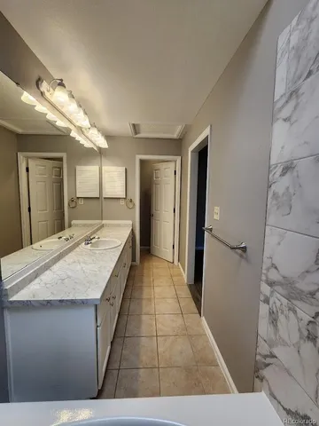 a large bathroom with a granite countertop sink a large mirror and shower