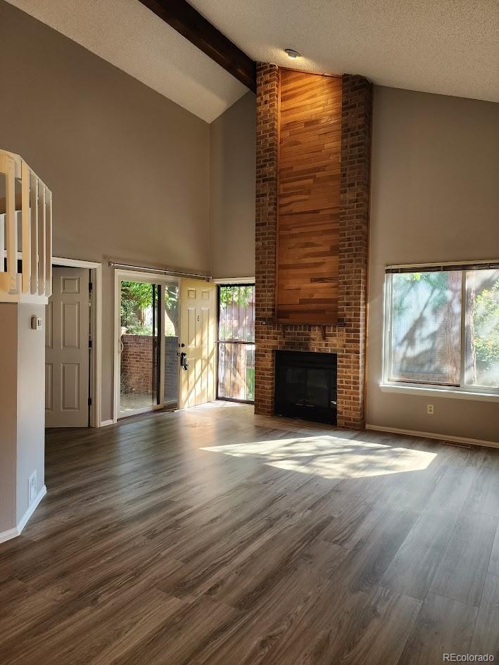 2685 South Dayton Way, Unit 365 Denver, CO 80231 - Photo 6 of 24 an empty room with wooden floor fireplace and windows