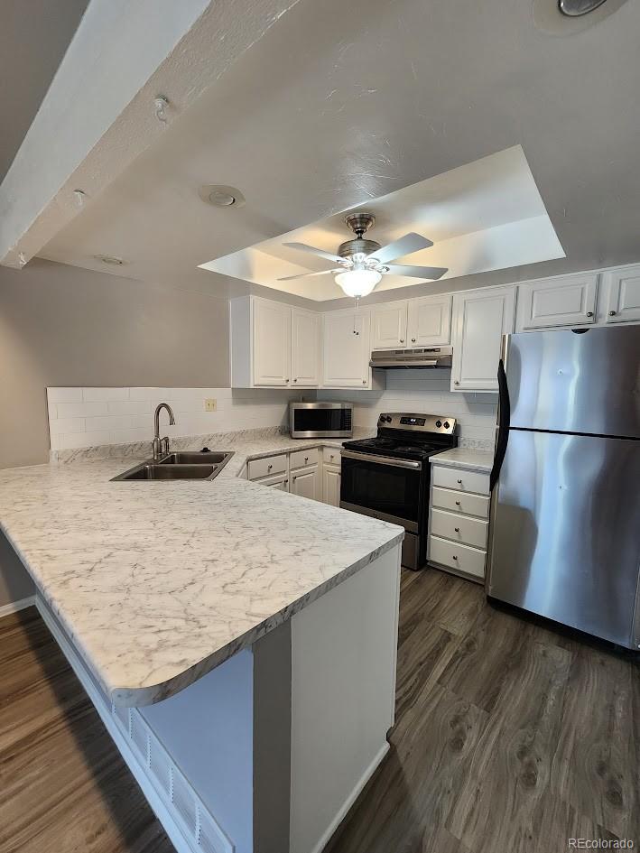 2685 South Dayton Way, Unit 365 Denver, CO 80231 - Photo 8 of 24 a kitchen with granite countertop a refrigerator and a stove top oven