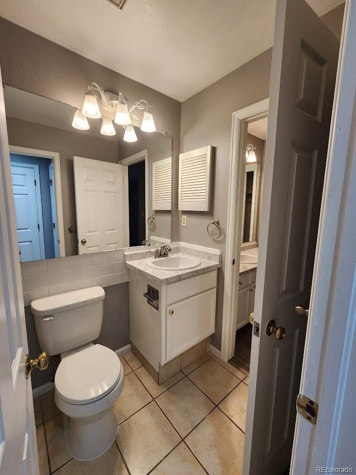 2685 South Dayton Way, Unit 365 Denver, CO 80231 - Photo 10 of 24 a bathroom with a toilet sink and mirror